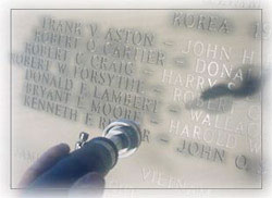 a worker inscribes the names of fallen alumnin on the new plaques