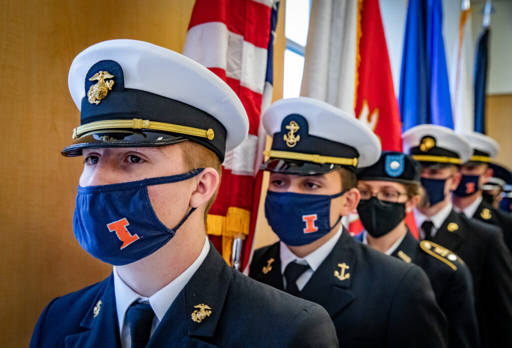 Dan Kane, front left, and other members of the University of Illinois ROTC Tri-Service Color Guard present the colors as area veterans during a Veterans Day Celebration at the Chez Veterans Center.
